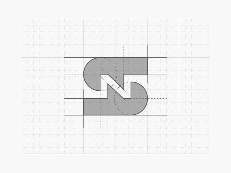 Monogram SN dựng trên lưới: hai nửa chữ màu xám, khe chéo ở giữa tạo thành nét của chữ N