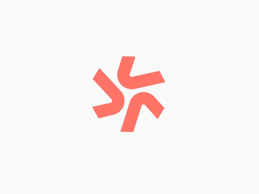 Logo Spark Mark màu san hô: sáu nét dày bẻ cong xoay quanh tâm thành một tia sáng nhiều cánh
