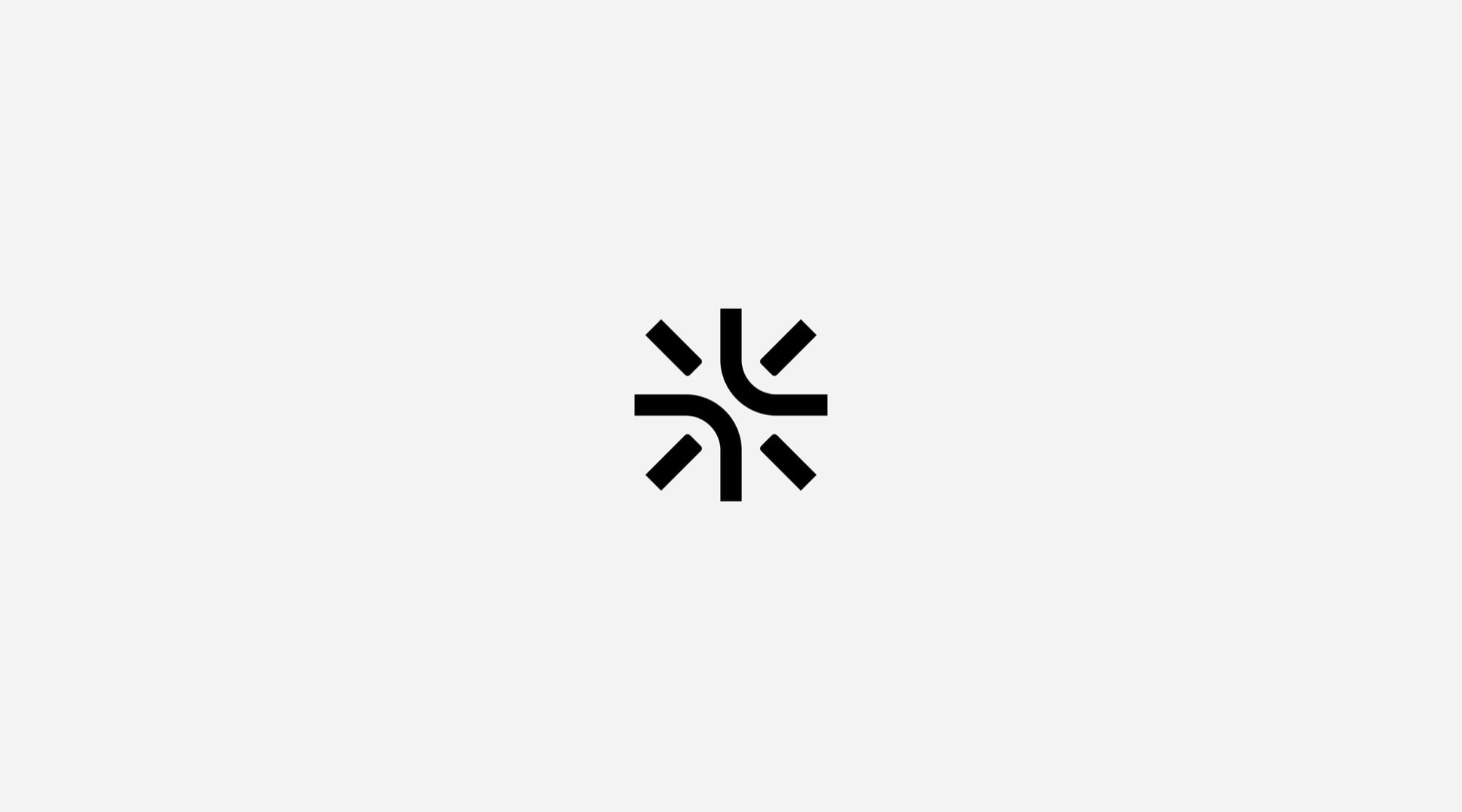 Logo ngôi sao đen trên nền xám nhạt: tám nét thẳng và hai nét cong đối xứng tạo thành một tia sáng