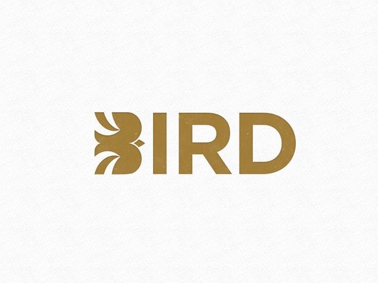 Logo chữ BIRD màu vàng đồng trên giấy trắng: chữ B được thay bằng hình con chim dang cánh, khoảng trắng giữa hai cánh tạo thân chim