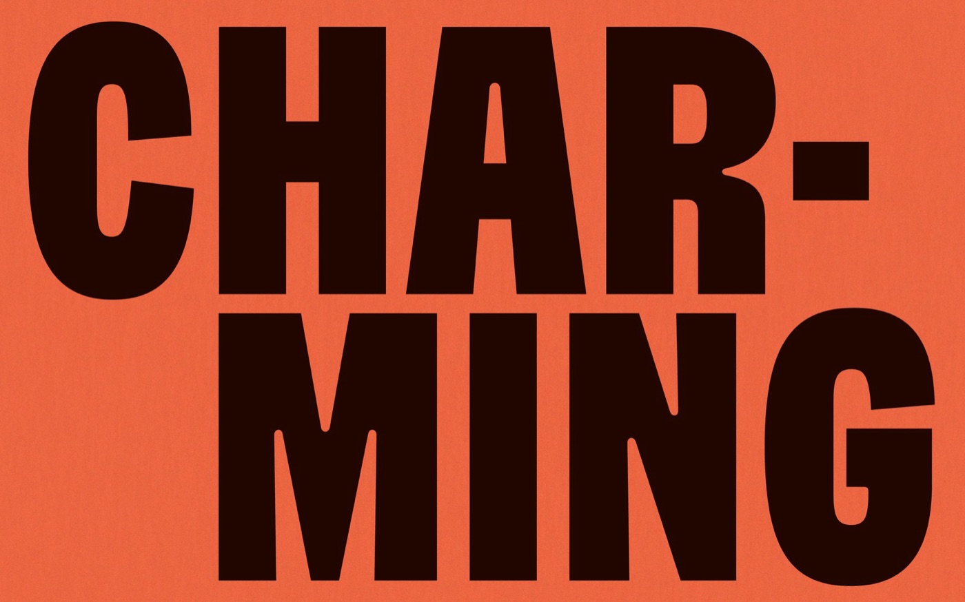 Chữ CHAR-MING rất đậm, hẹp, màu nâu đen, chiếm gần hết khung nền cam đất